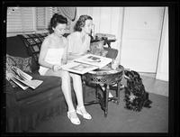 Two Women on a Sofa Looking at a Photo Album