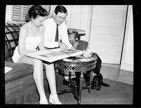 Man and Woman on a Sofa Looking at a Photo Album