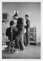 Two doctors giving patient a dental exam