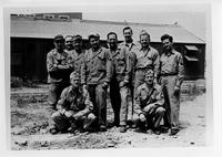 Group of ten soldiers posing together outside