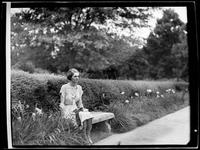 Woman Sitting on a Garden Bench