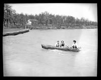 Three People in a Rowboat on a Lake