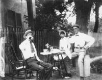 Outdoor snapshot with men and refreshments.