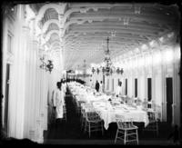 Interior view of an Anchor Line steamboat's salon set for a meal.