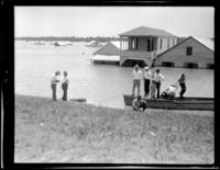Men and boy on levee and pirogue