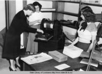 Librarian Mary W. Harris operating a mimeograph machine at the State Library in Baton Rouge Louisiana in 1950
