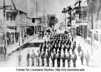 Southwestern Louisiana Industrial Institute (SLII) cadet corps parading on Jefferson Street.